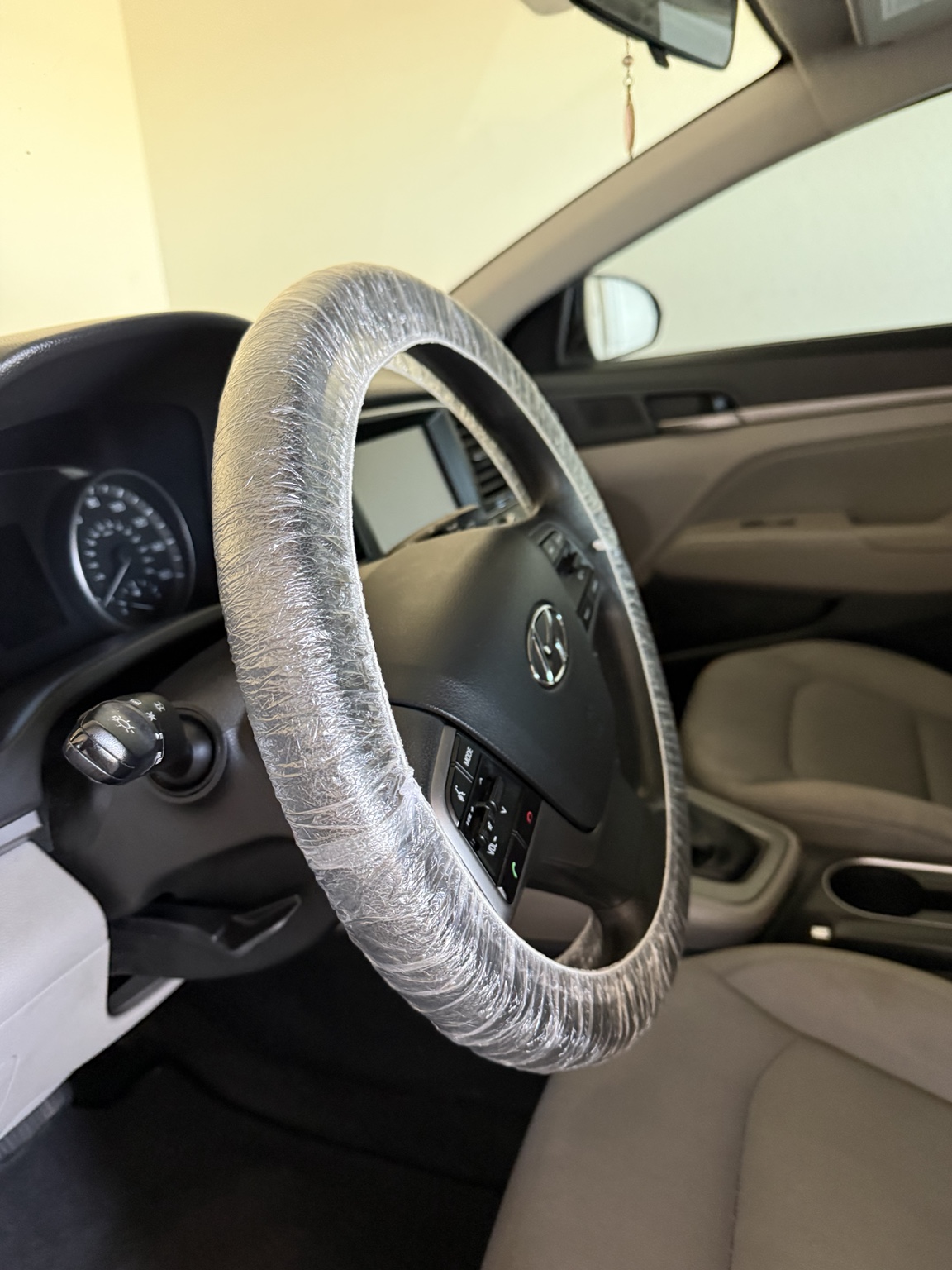 Cleaned vehicle interior from Raven Auto Detailing, with a protected steering wheel